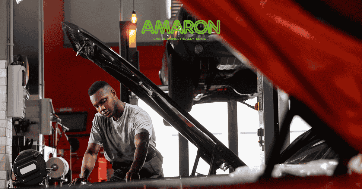 Mechanic inspecting battery and alternator to prevent battery drain and ensure proper charging