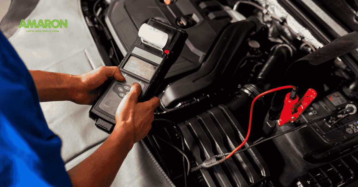 Man holding a battery meter assessing a car battery